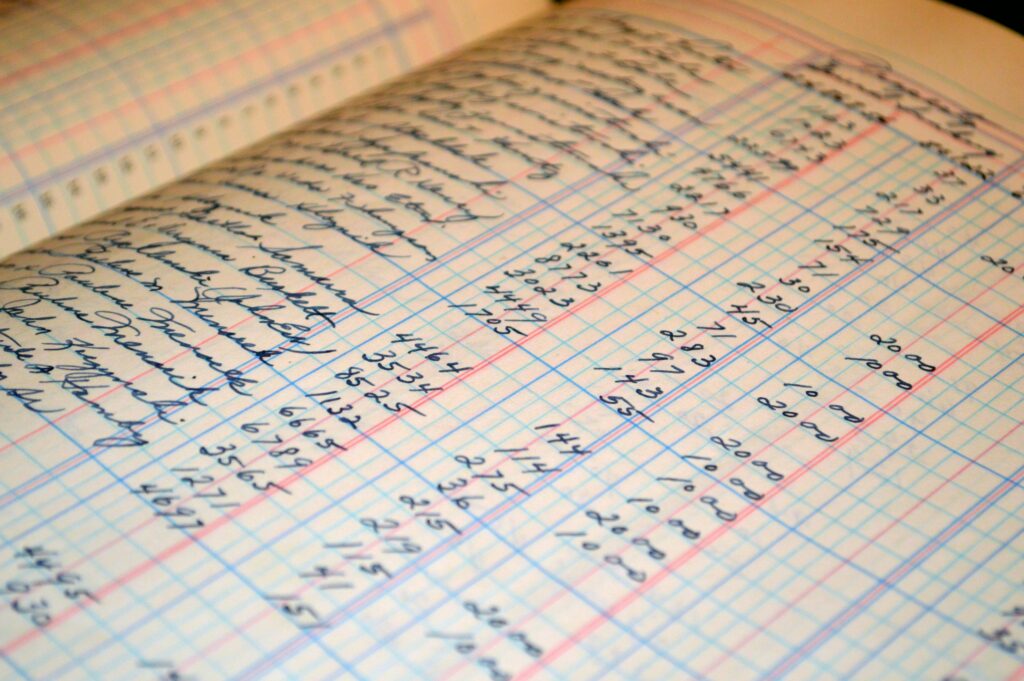 pexels-photo-164686-164686 Close-up of a vintage handwritten ledger detailing financial records and accounts.